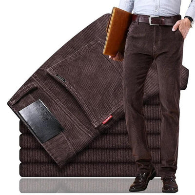 premium corduroy pants for men display with stacked pairs and a model holding a leather folder.